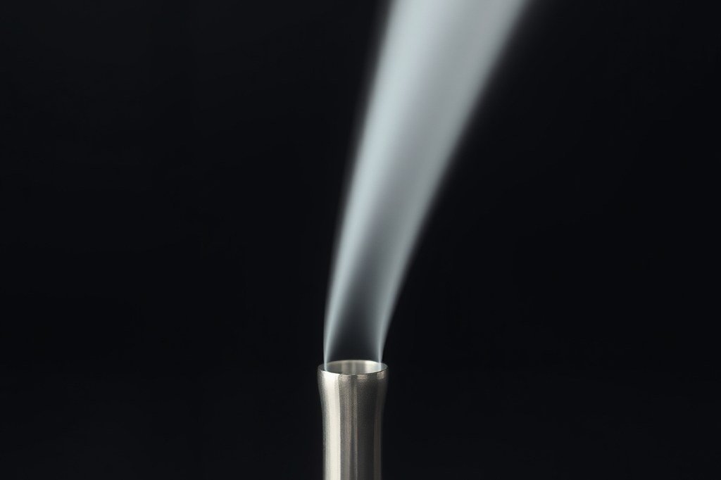 Chorro de vapor saliendo de la punta limpia de un tubo vaporizador de acero